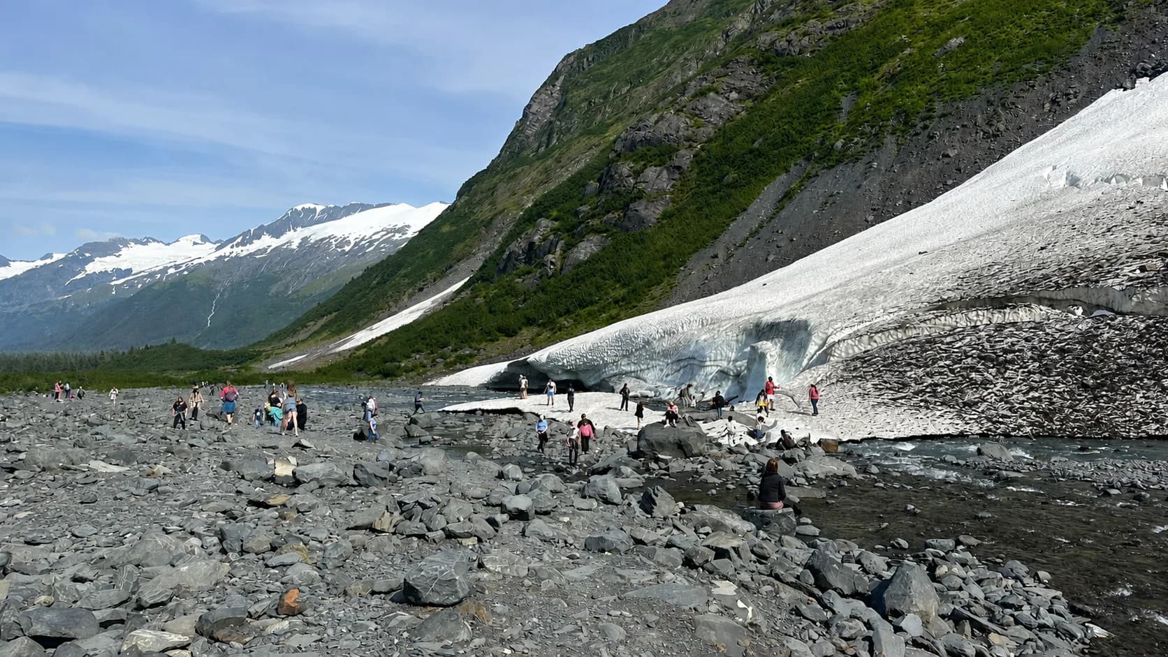 The boulder field and glacial runoff creek near the base of the valley below Byron Glacier, with residual lower snow and ice