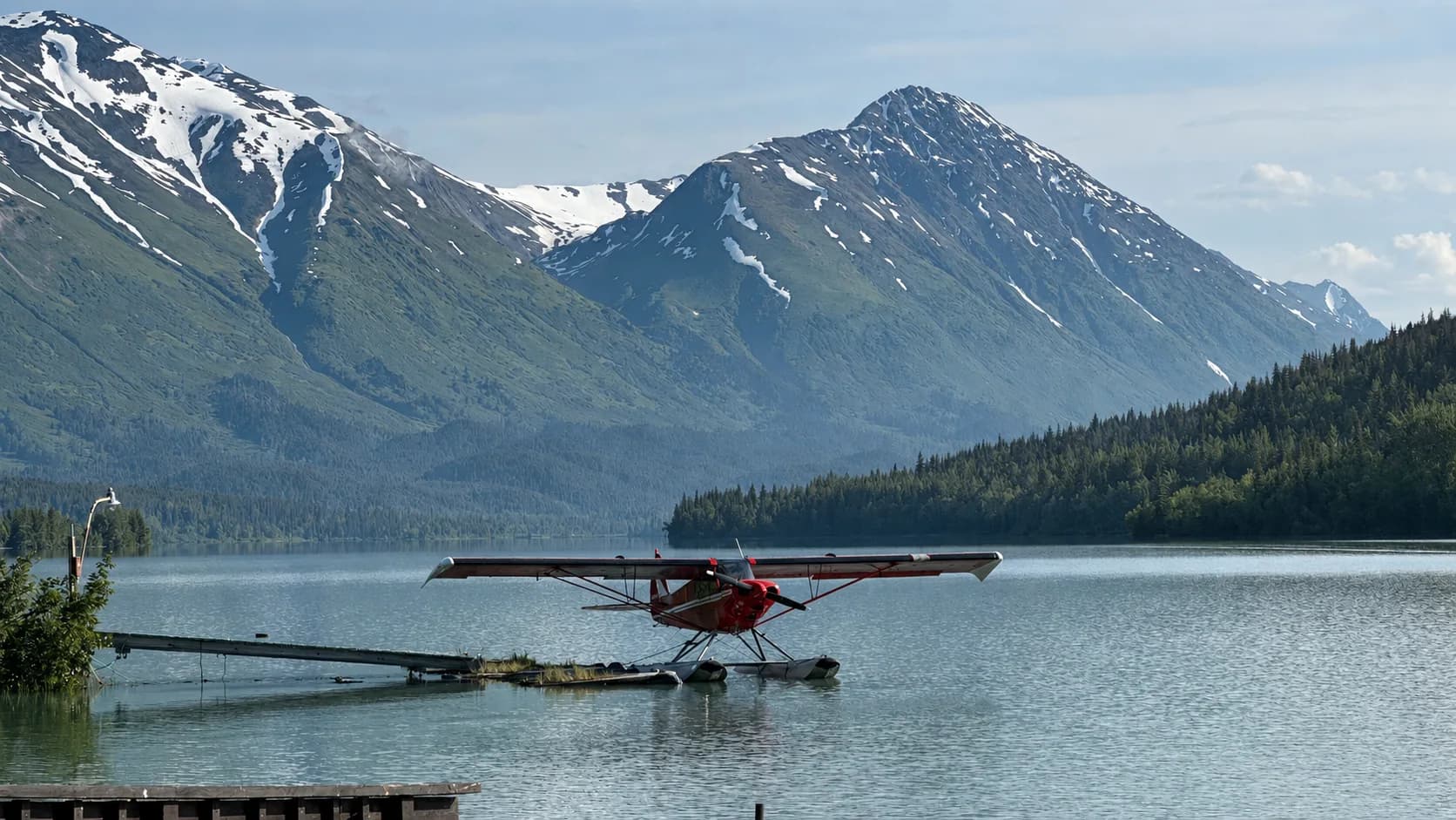 A floatplane on Upper Trail Lake near Moose Pass, with the Chugach Mountains behind